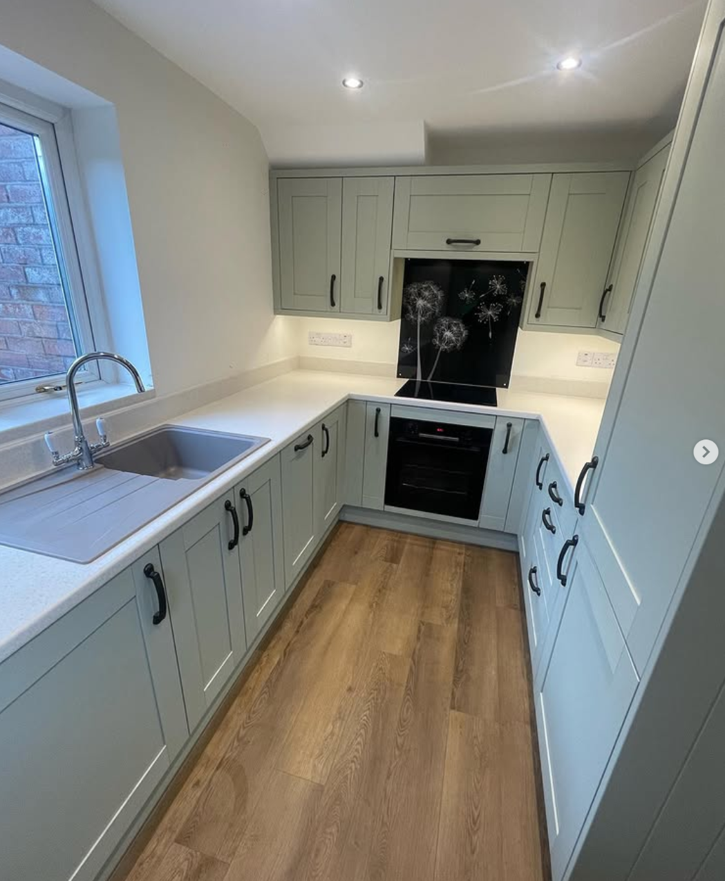 Sage green kitchen with quartz worktop